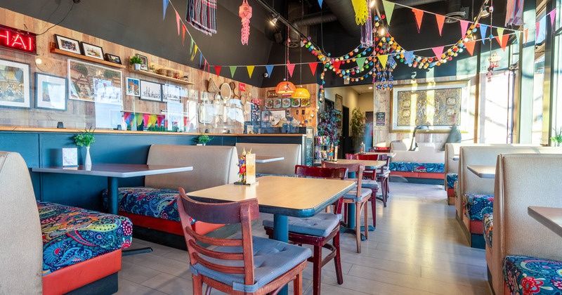 Colorful restaurant interior with bunting and patterned seating