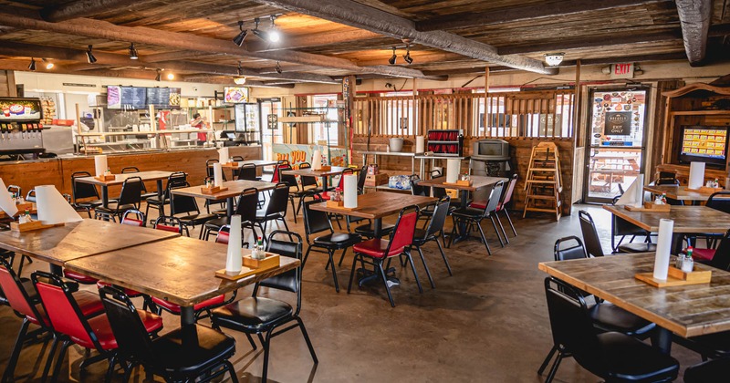 Interior, tables and chairs, checkout counter in the back, restaurant entrance