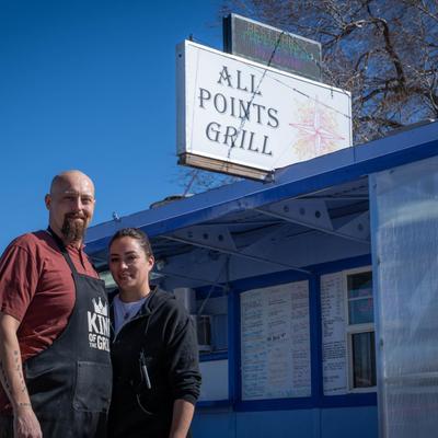 Staff posing for a shot in front of the restaurant.