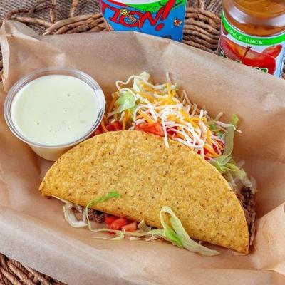 Hard-shell taco served with dipping sauce on the side.