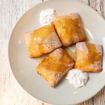 Delicious puffy sopapillas with drizzle of honey.