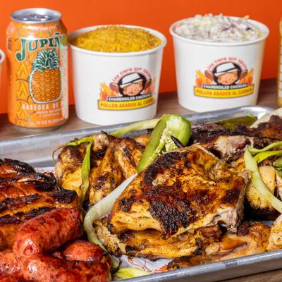 Grilled meats platter with rice and coleslaw on the side.