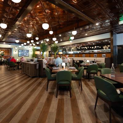 Elegant restaurant interior, people dining, creating a cozy atmosphere.