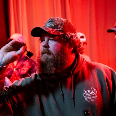Person throwing dart at the dartboard, close-up.