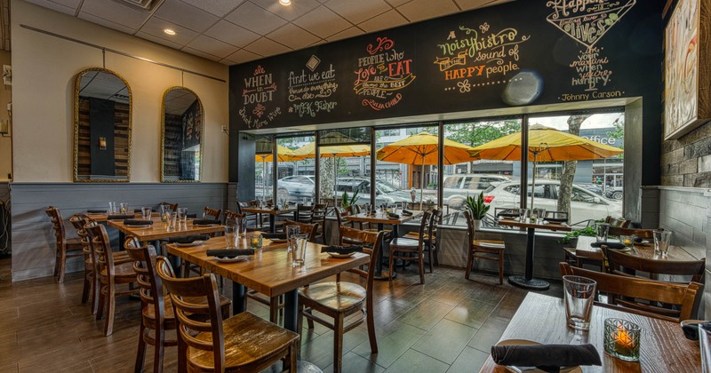 Interior, dining area, wooden top tables with chairs, large shop window, tile flooring