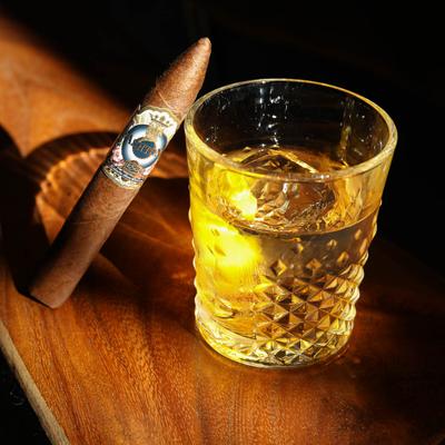 Cigar by a glass of Sazerac