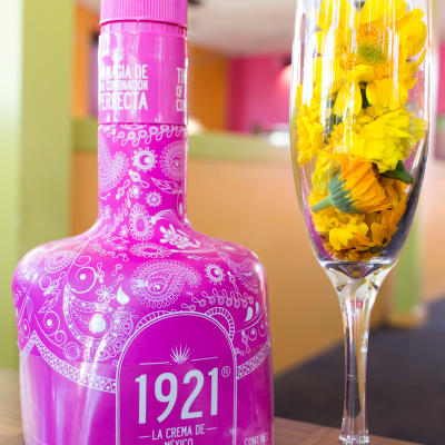 A tequila cream bottle and a glass.