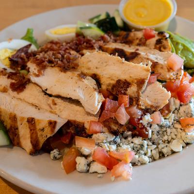 Grilled chicken salad, with greens, cucumber, tomato, onion, and blue cheese crumbles.