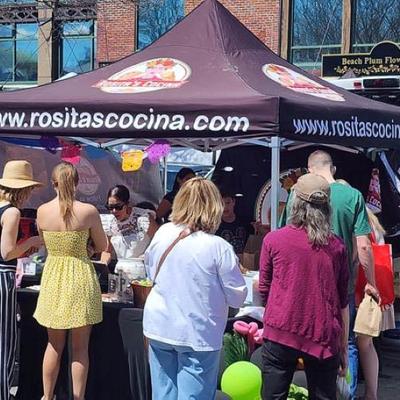 Customers standing in front of Rosita's Cocina Mexican street food stand.