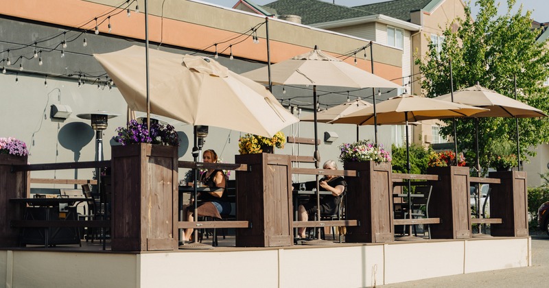 Exterior, terrace, tables and chairs, parasols, guests