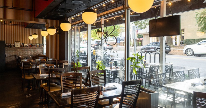 Interior, tables and chairs lined up next to the windows