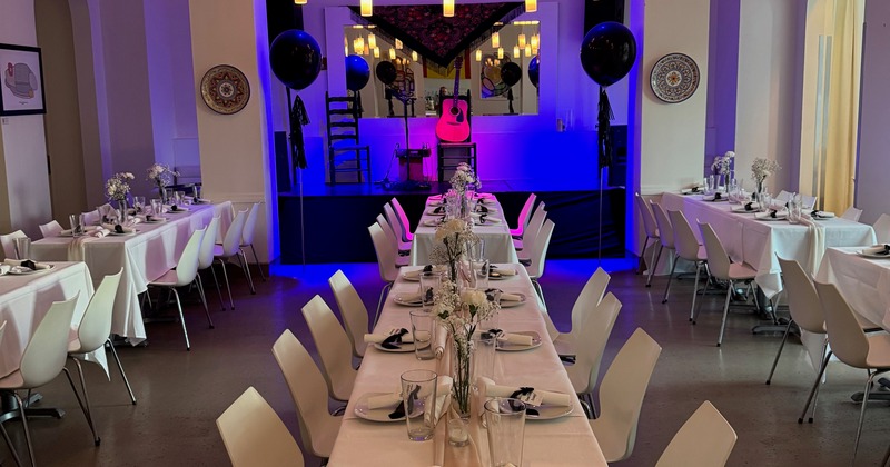 Banquet hall  space set up for a celebration with a music stage