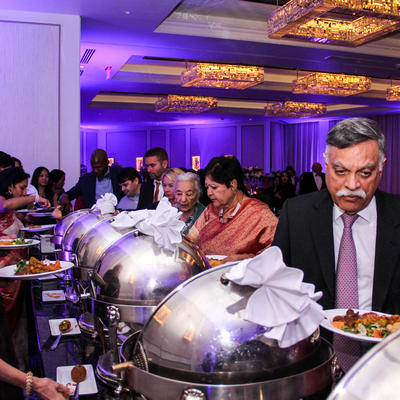 Older man with mustache by the catering table