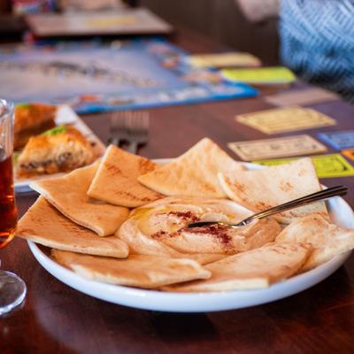 Hummus and pita served on a plate.