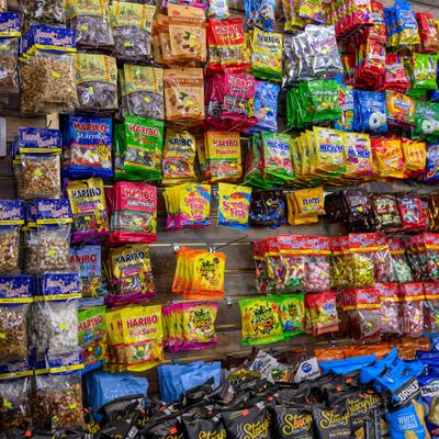 Display rack filled with small, brightly colored snack packets.