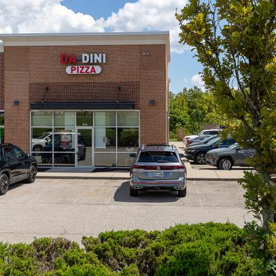 Da Dini Pizza  storefront with parked cars outside.