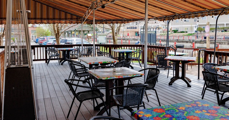 Exterior, patio, covered seating area, tables with chairs, outdoor space heaters