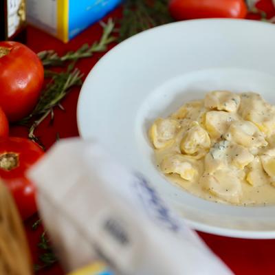 Creamy pasta served in a white bowl.
