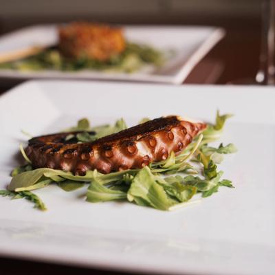 Grilled octopus with arugula.
