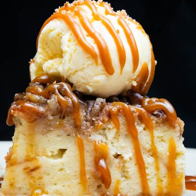 Caramel cake topped with a scoop of vanilla ice cream.