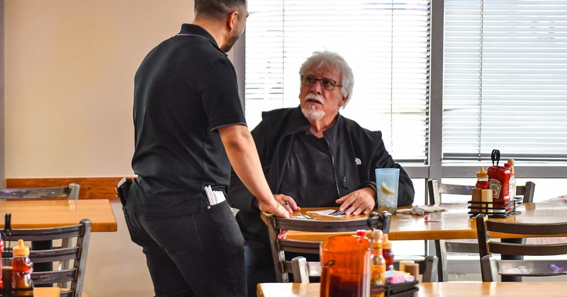Diner area, tables and chairs, guest and staff