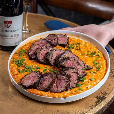 Wood fired hanger steak on Parmesan risotto a la bolognese.