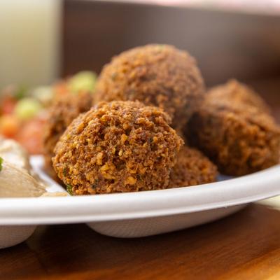 Falafel served on a platter with sides, close-up.
