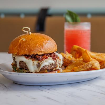 Southern Comfort Burger and fries with a red cocktail drink