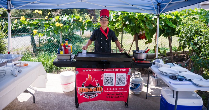 Chef posing at outdoor hibachi grill station