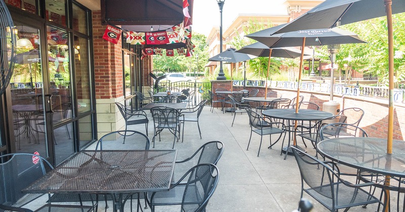 Outdoor seating area, tables, chairs, and parasols