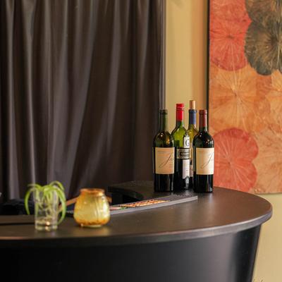 Circular desk with wine bottles.