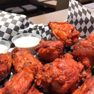 Basket of Ten spicy chicken Wings with ranch drressing cups