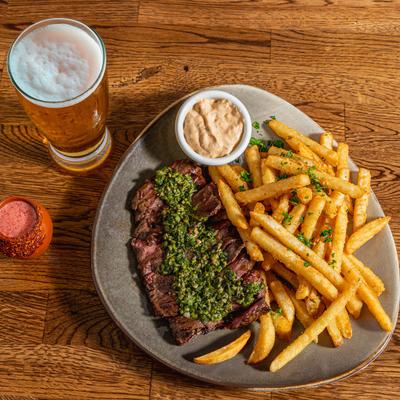 Skirt steak and fries with chimichurri.