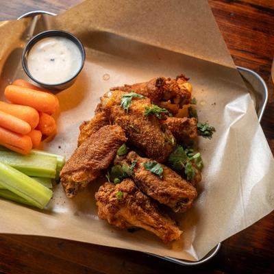 Dragon Dust wings served with baby carrots, celery and a dipping sauce.