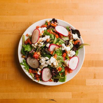House salad with radishes and crumbled cheese.