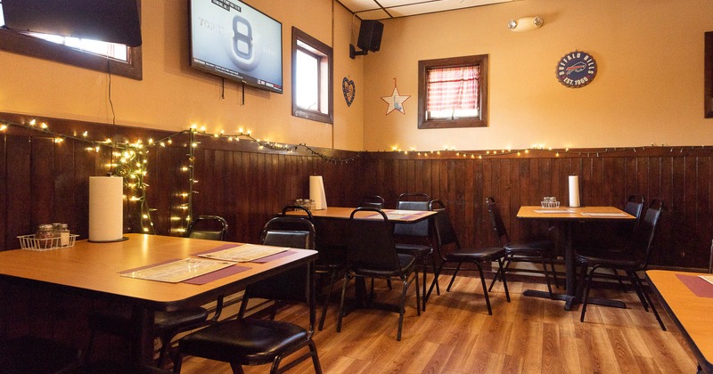 Interior, seating place with tables and tv on the wall