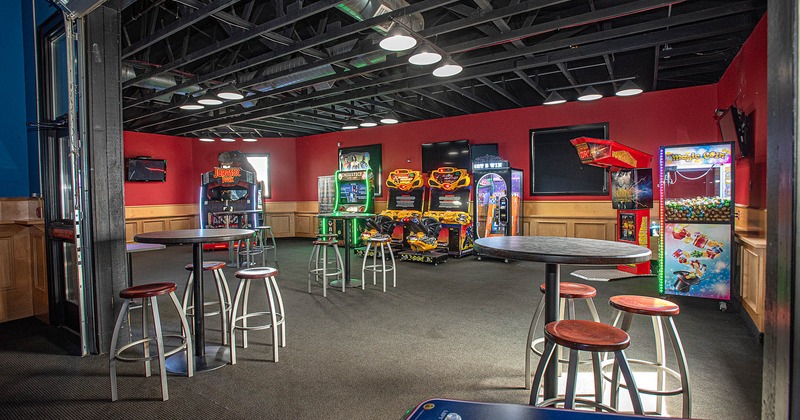 Interior, a game room with arcade consoles