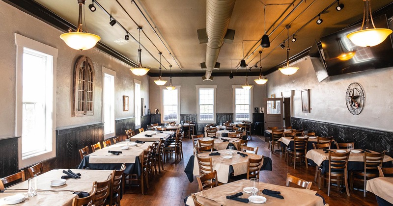 Spacious dining area with tv screens on the wall