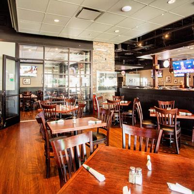 Interior with wooden tables and a bar.