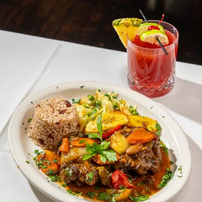 Braised oxtail with sauteed veggies and rice.