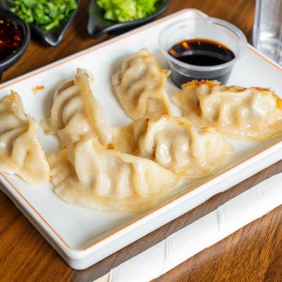 Pan-fried dumplings with soy sauce.