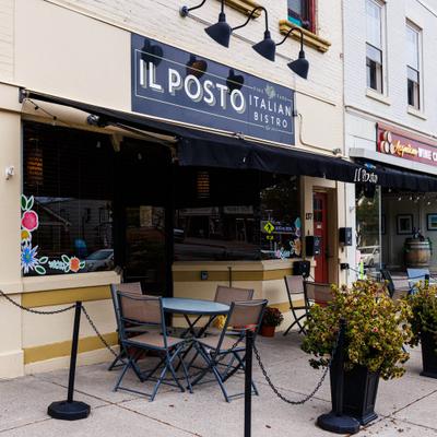 Il Posto Italian Bistro exterior with black awning and outdoor seating.