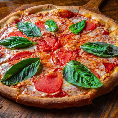 Margherita Pizza with mozzarella, Roma tomato, basil and extra virgin olive.