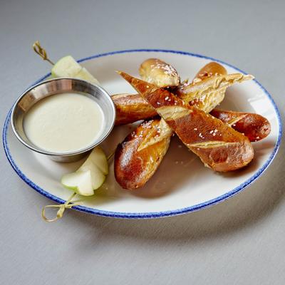 White cheddar fondue, served, side view.