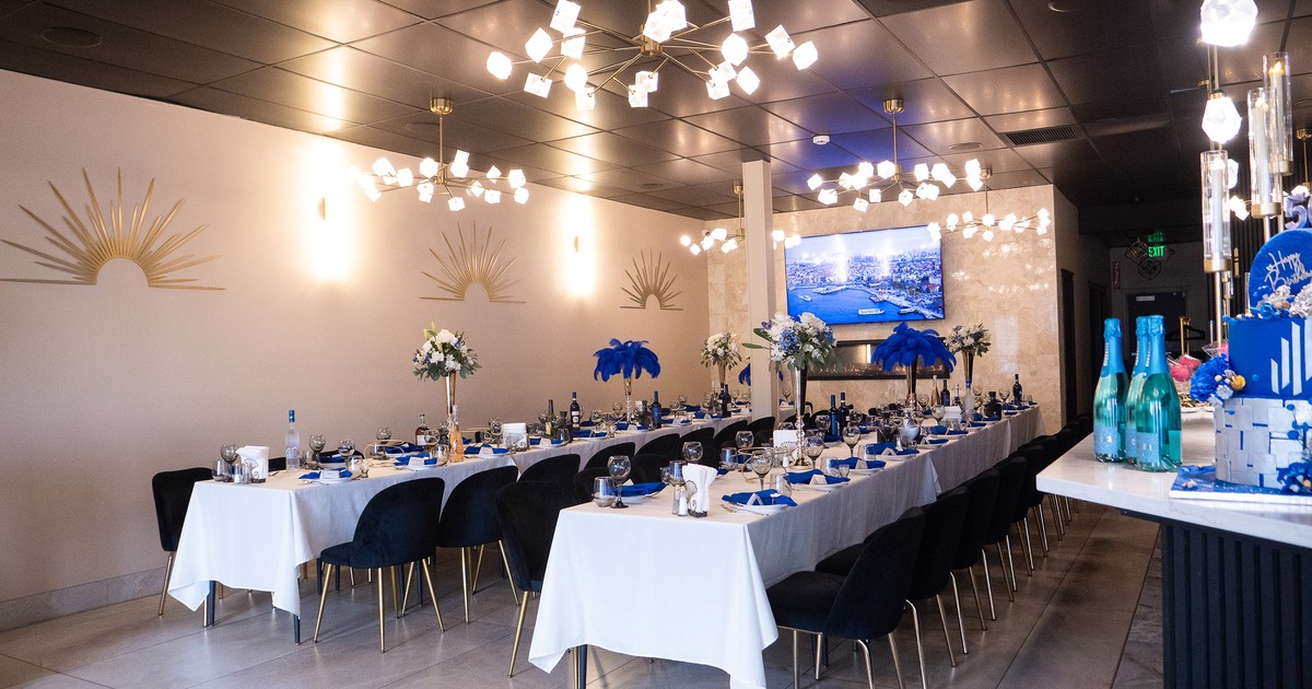 An elegant and nicely done event space room with set tables prepared for a celebration