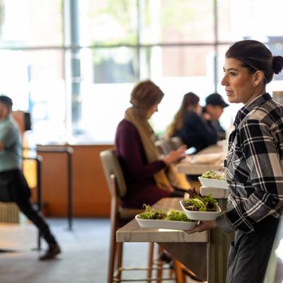 Server carrying entrees at Southpark Seafood in downtown Portland