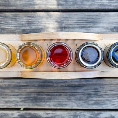 Colorful beer flight on the wooden board.