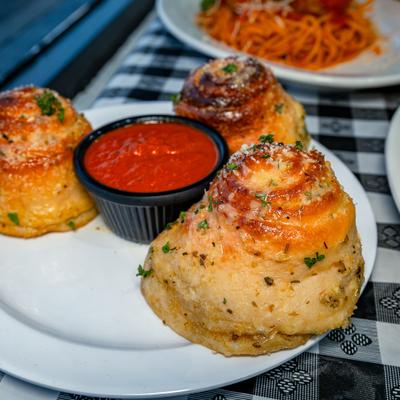 Garlic knots served beside marinara.