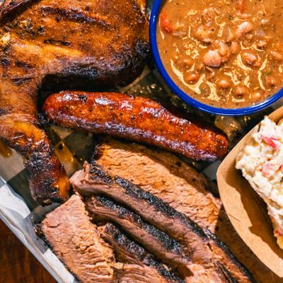 BBQ Combo platter, with brisket, chicken, sausage, coleslaw, and beans.