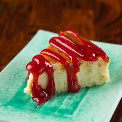 Cheesecake with strawberry drizzle.